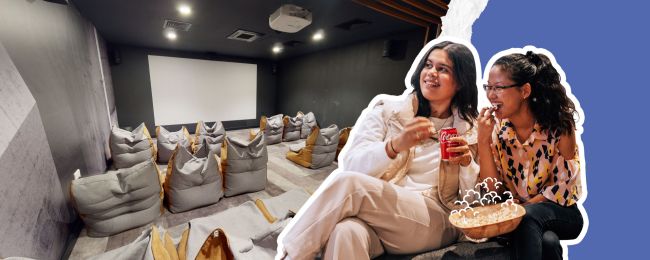 Cinema Space with two students eating pop corn