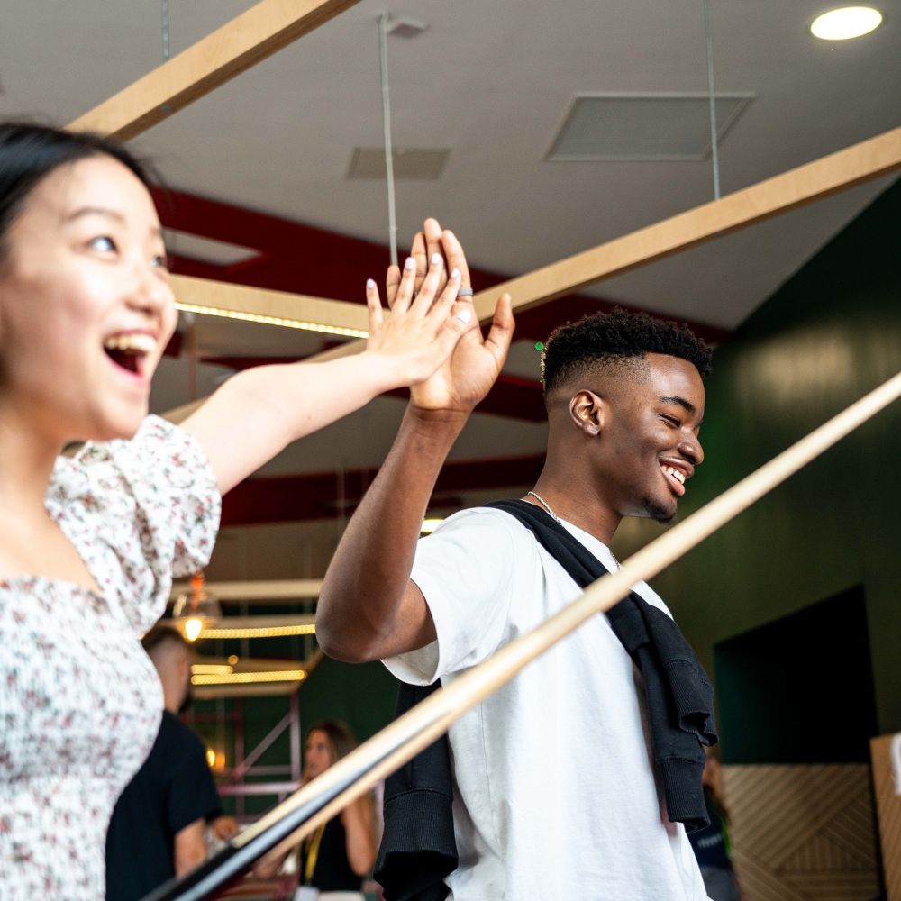 Two students high-fiving